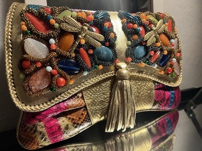 This unique accessory is a genuine python leather handbag handcrafted