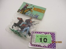 Plastic cowboy figures in still sealed packet.