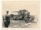 Photo soldiers of the Luftwaffe shooting with 88 anti-aircraft gun at earth targets...