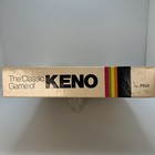 Vintage 1976 Classic Games Co. box with gold logo, “THE CLASSIC GAME OF KENO” text, and multicolor stripe at bottom.