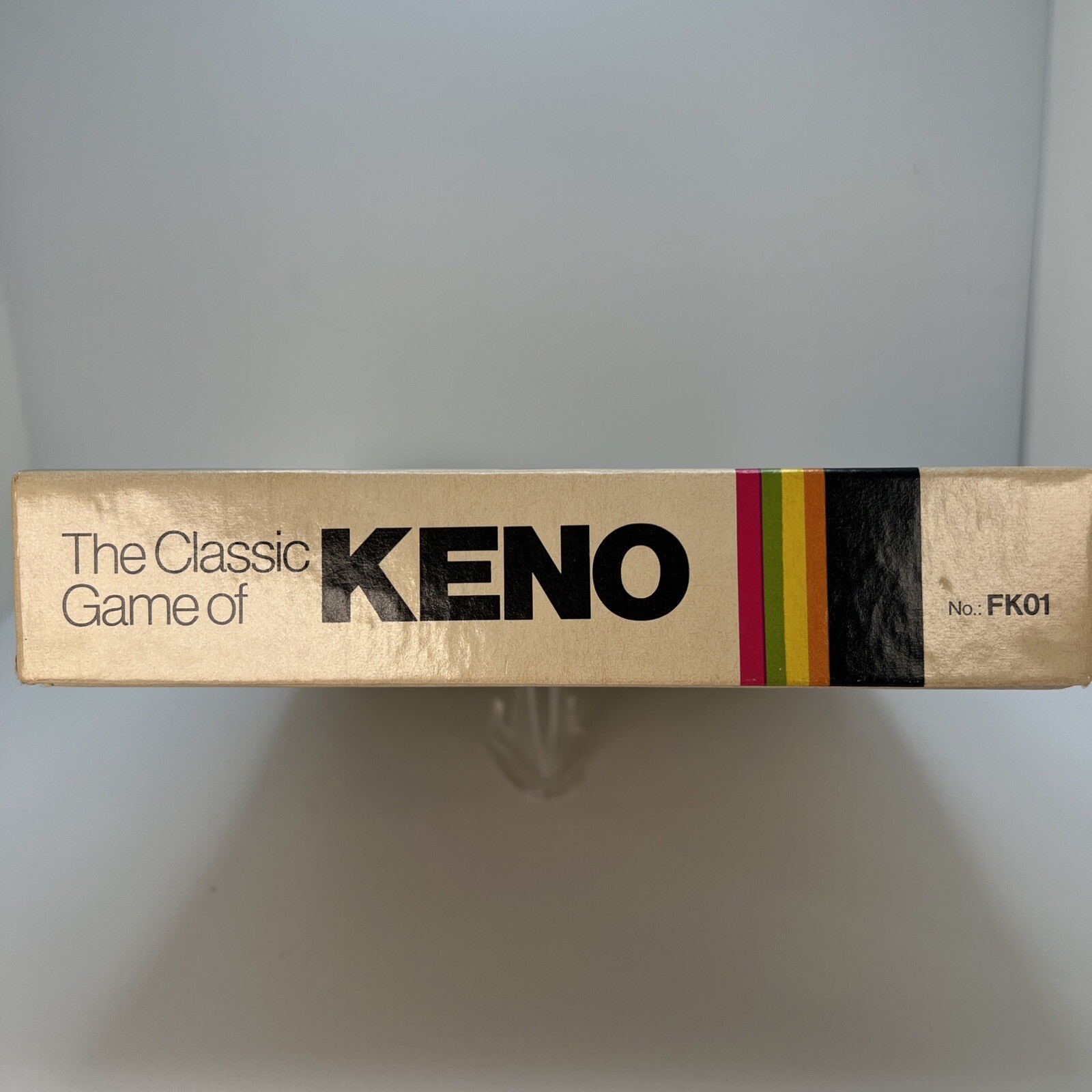 Vintage 1976 Classic Games Co. box with gold logo, “THE CLASSIC GAME OF KENO” text, and multicolor stripe at bottom.