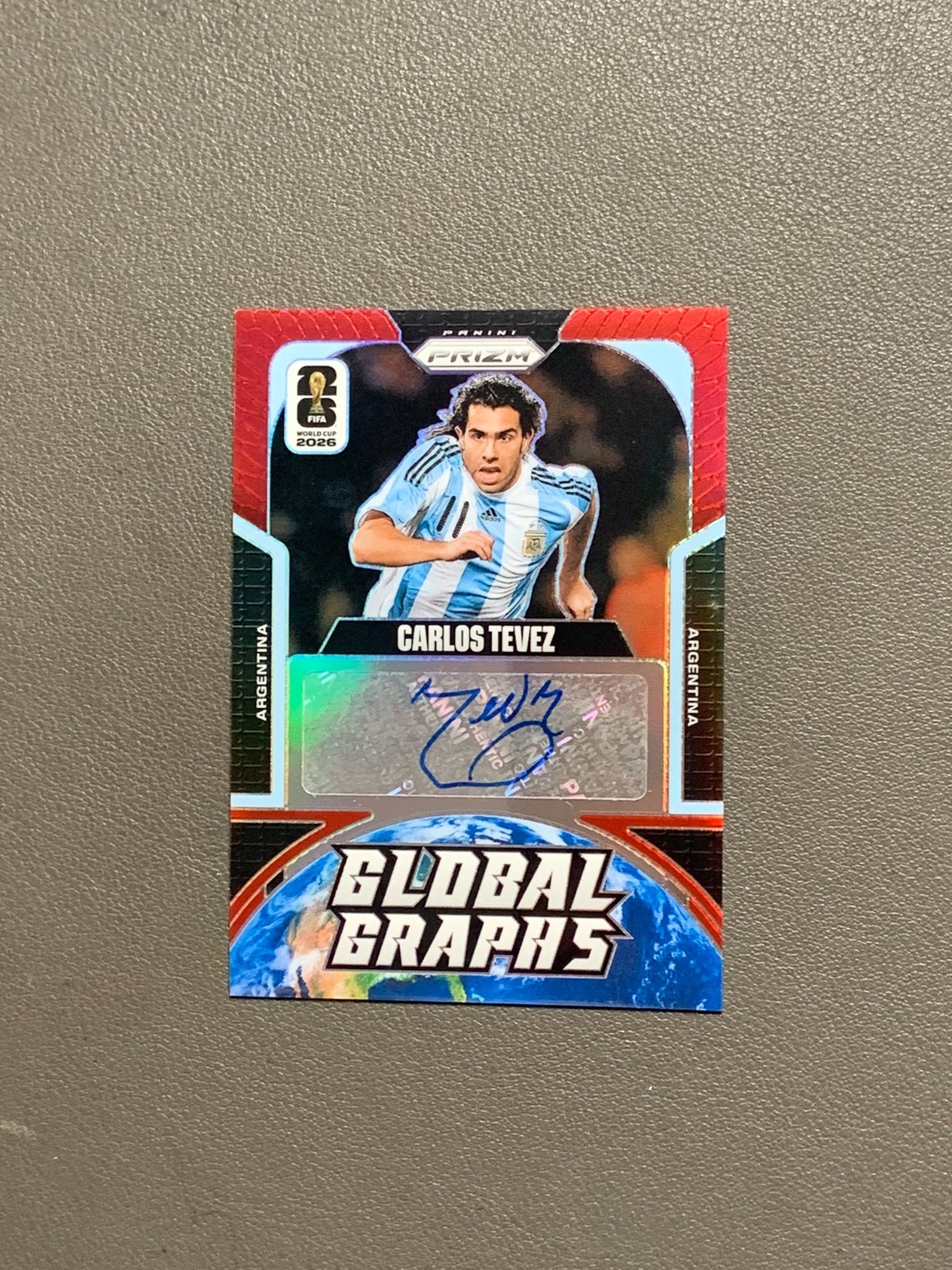 2026 Panini Prizm World Cup Carlos Tevez Global Graphs Red Prizm Auto 26/49 
