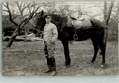 39803482 - A German Landser with his horse on the reins somewhere in