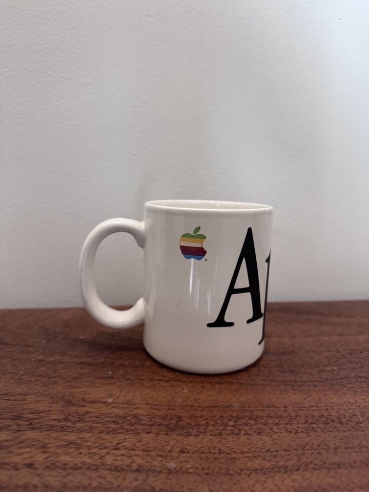 An original 1980s Macintosh-era mug bearing the legendary rainbow Apple logo — rare, iconic, and deeply nostalgic for anyone who grew up in the dawn of personal computing.
