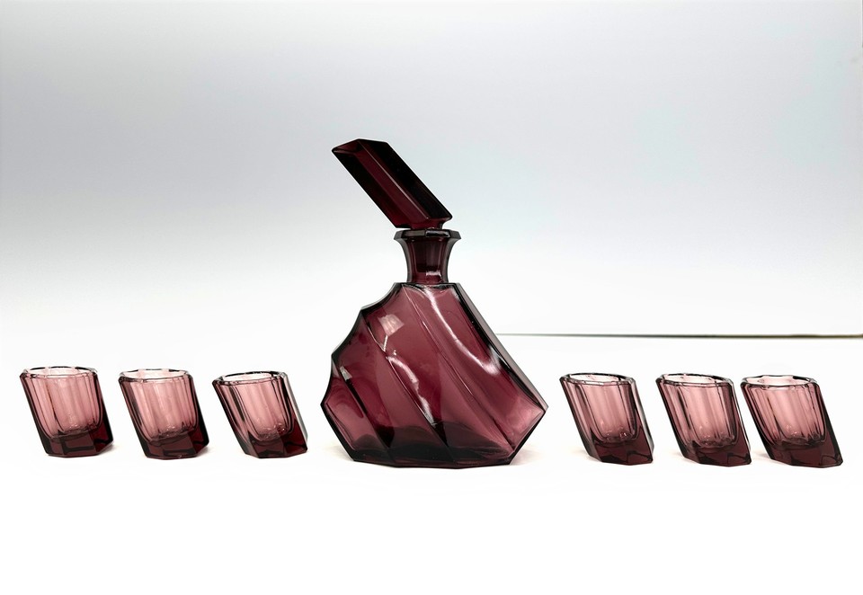 A Josef Inwald amethyst pressed glass decanter set from 1938 — still with its original label, making it a genuinely rare documented piece of pre-war Czech glass history.