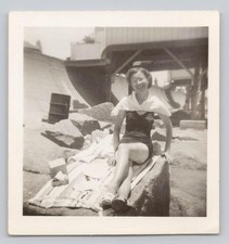 1940s Fun Swimsuit Lady Sunbathing on Rocky Beach by Pier Named Vintage Photo