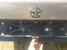 US CARS license plate holder with spring fold up fuel filler flap lock Le Baron