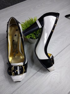 white heels with gold accents