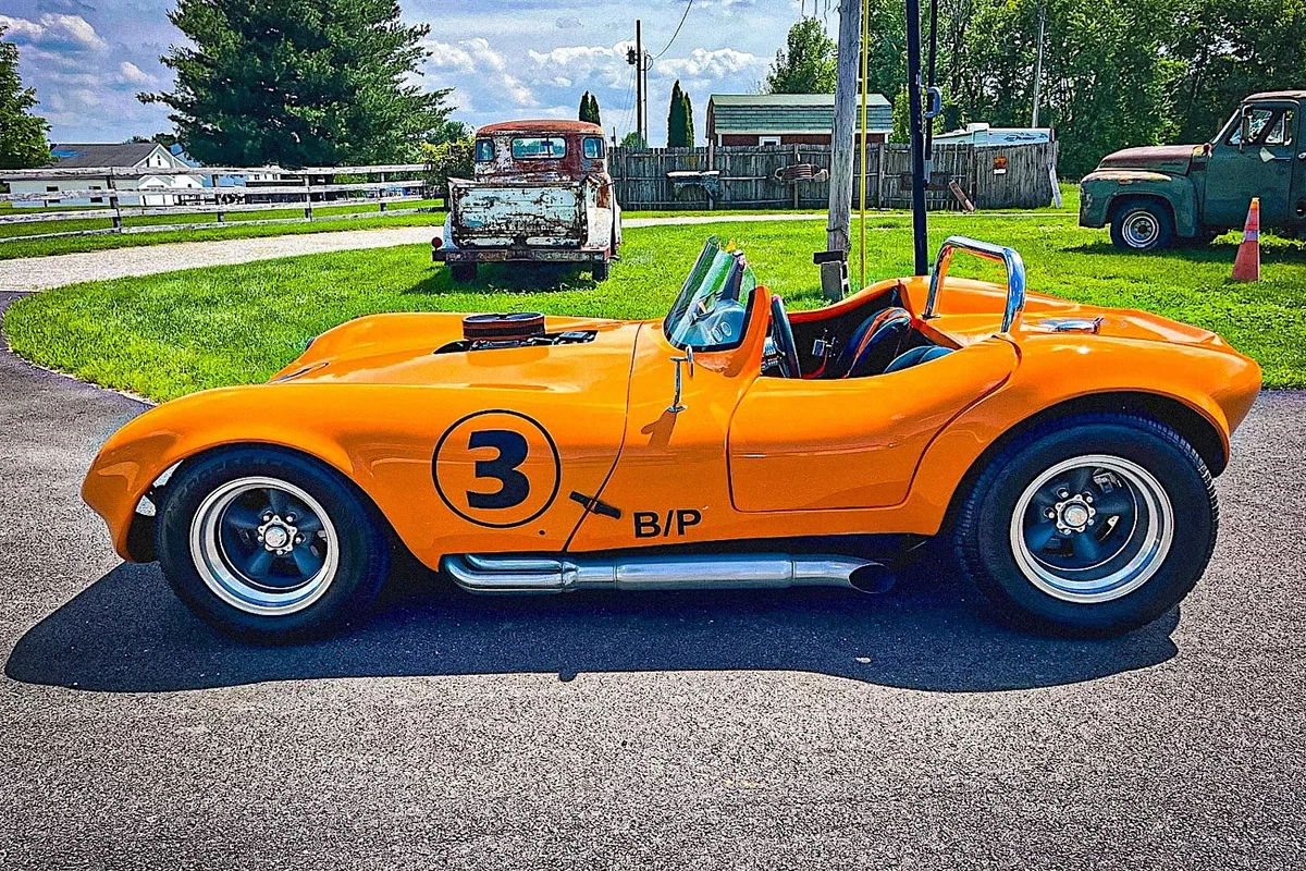 Left side profile of an orange Cheetah replica.