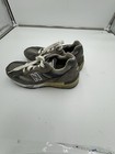 Grey dark grey New Balance 991 sneakers size 7 with white laces, tan insoles, and “Made in USA EUC” text on side.