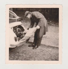 A Man Analyzes The Back Of A Car With An Engine Unusual Snapshot Old Photo