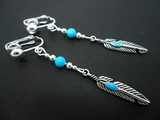 A PAIR OF  TIBETAN SILVER DROP DANGLY  FEATHER THEMED  CLIP ON EARRINGS. NEW.