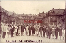 RPPC - twenty-three tourists pose in front of PALAIS DE VERSAILLES - FRANCE.