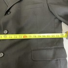Black solid three-button blazer jacket with notch lapels, front pockets, and yellow measuring tape across the chest.