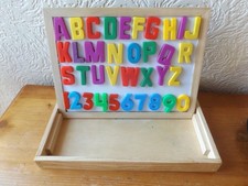 WOODEN BOX WITH 36 MAGNETIC LETTERS AND NUMBERS.