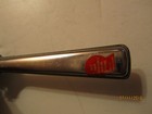 Silver Playtex hair cutter with red “Made in U.S.A.” label and black handle featuring visible branding and text.