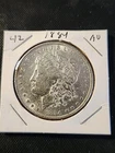 1884 Morgan Silver Dollar In About Uncirculated Condition