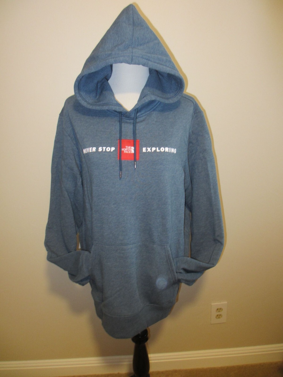 The North Face Mens Blue Pullover Hoodie With "Never Stop Exploring" Graphic Lar