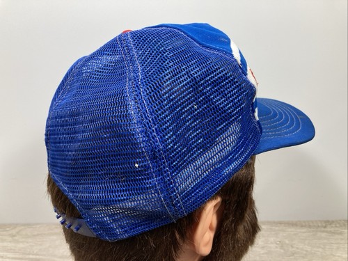 Blue US-made wide-stripe trucker hat with white and red shoulder panels and embroidered “VTG Chicago Cubs” text on front.
