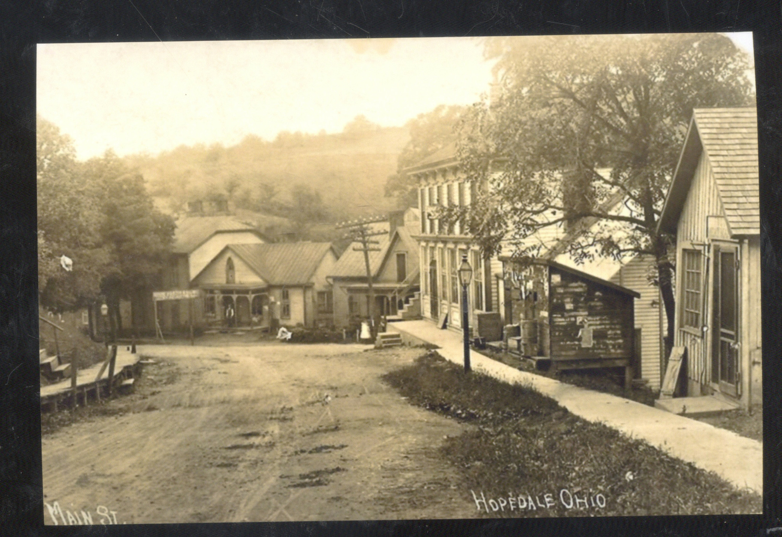REAL PHOTO HOPEDALE OHIO DOWNTOWN DIRT MAIN STREET SCENE POSTCARD COPY