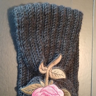 black knitted wool headband with rose on it very nice.