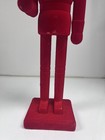 Red Christmas toy soldier with gift in hand ￼ — photo 3