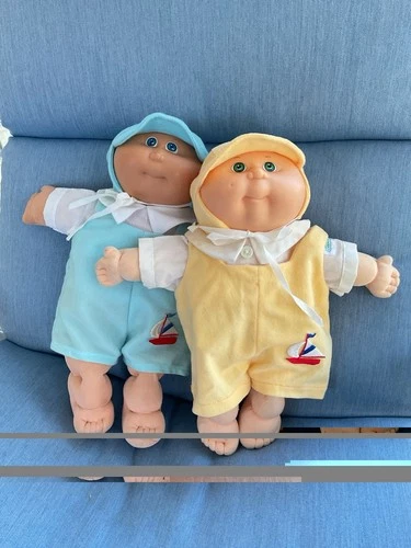 Two Vintage Cabbage Patch Dolls with 2 additional outfits