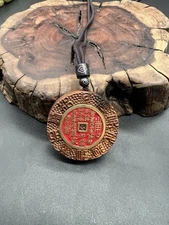 Lightning-struck ujube wood inlaid with the “Mountain Ghost” coin雷击枣木镶嵌山鬼花钱吊坠