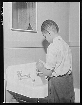 Mr. Frank Merchant washes his hands before going down to dinner. They have a