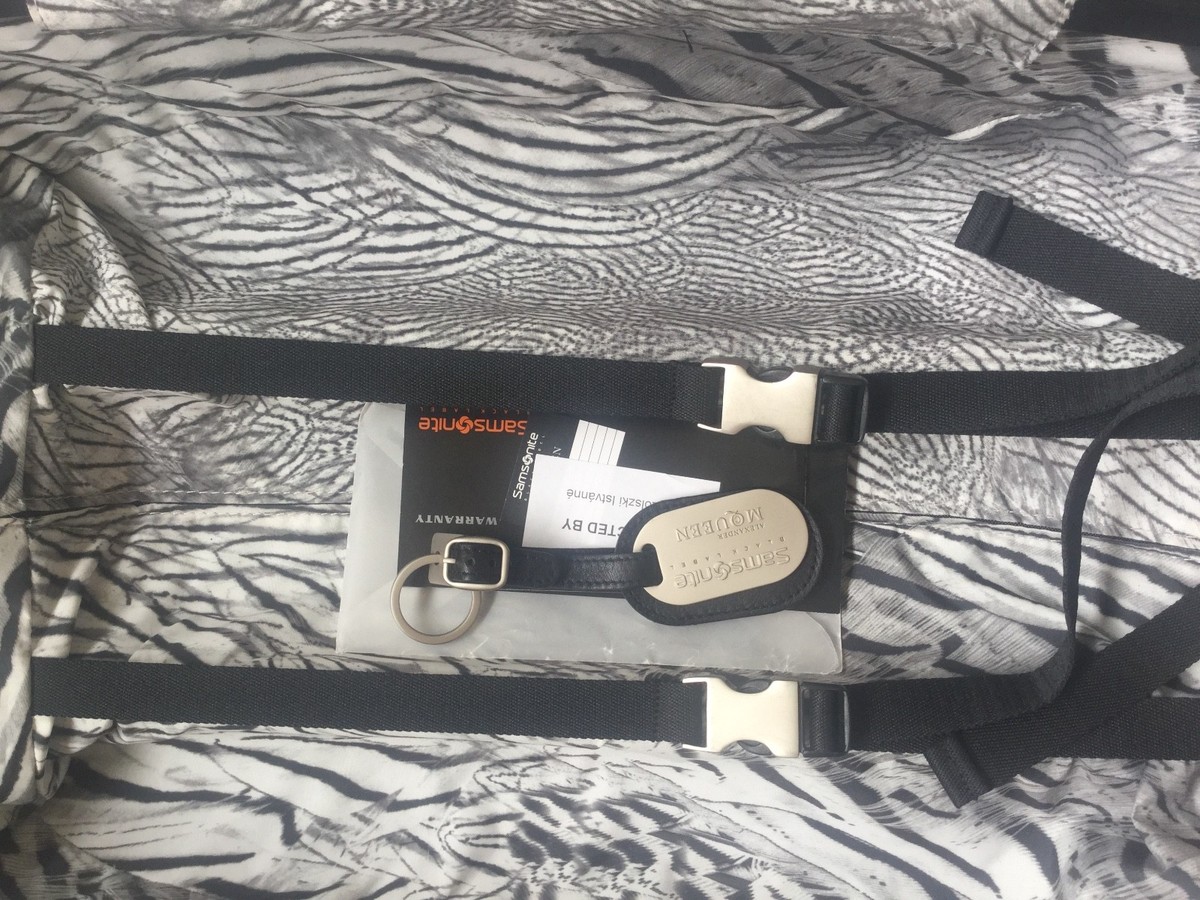 quick answers Alexander McQueen x Samsonite Ribcage Hero Trolley Brown Luggage a