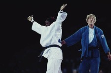 Cuban judoka Sibelis Veranes raises her arms in the air after winn- Old Photo