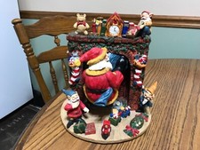 Santa climbing out of fireplace, elves, toys gifts, rare Christmas Figurine