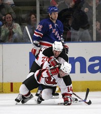Jay Pandolfo New Jersey Devils jumps on top of Brian Gionta - Ice Hockey Photo
