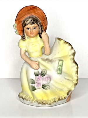 AA importing Girl In Bonnet Yellow Dress With Pink Roses. Bell 5.25H x 3.25W