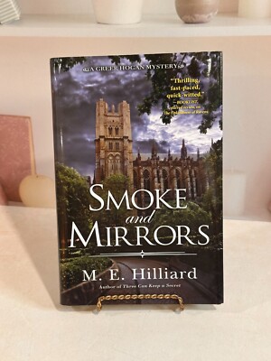 Smoke and Mirrors (A Greer Hogan Mystery) Hardcover 2024 by M. E. Hilliard