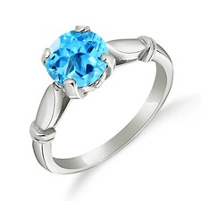 18K. SOLID GOLD SOLITAIRE RING WITH BLUE TOPAZ
