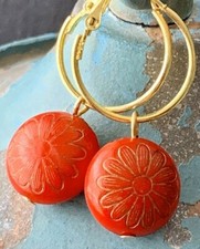 Red Flower and Gold Hoop Earrings.