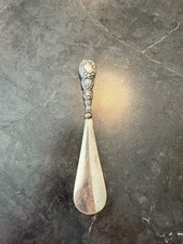 An ornate sterling silver Art Nouveau shoe horn by Broadway  Co.