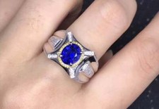 Vivid Blue Oval Cut 2.54CT Sapphire With Brilliant Cut White Yellow CZ Ring