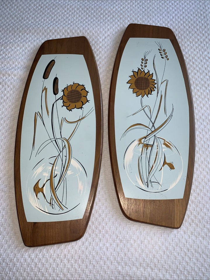 Large Belart teak wall hangings depicting goldfish bowl scenes — these are the kind of wild, specific, deeply groovy MCM wall art that stops guests cold.