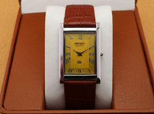 Vintage Seiko Slim Quartz Men's Wrist Watch Yellow Dial with Light Brown Strap.