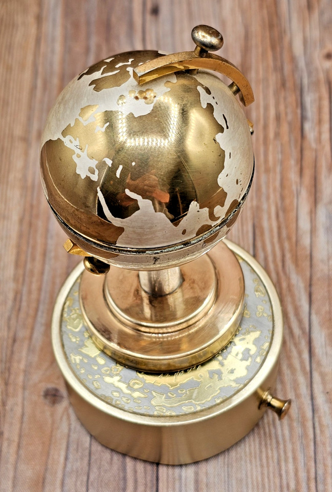 A spinning-globe lighter with a built-in music box, made in Japan — it's James Bond meets mid-century lounge bar in one object.