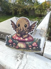 Cute Cryptid Cthulhu Reading on a Mushroom Vinyl Sticker