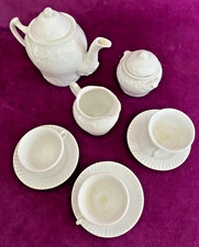 An antique child's china tea set. Ornate design.