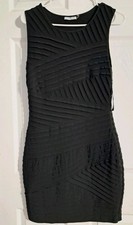 Black Calvin Klein dress, size 8, knee-length, with crisscross detailing.