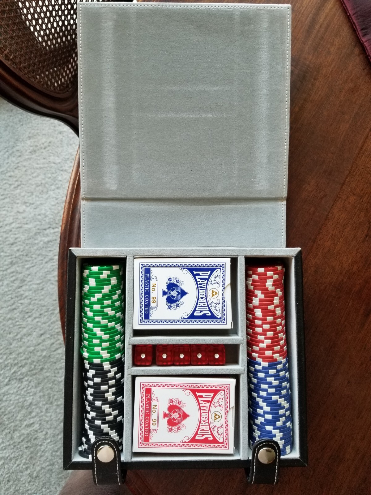 Leather-bound poker set with cards, chips, and dice