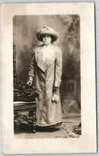 Postcard RPPC Pretty Woman Standing Big Hat Studio Portrait Coat Chair 1900s
