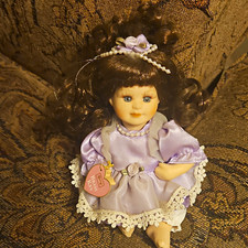 Porcelain Girl Doll with Brown Curly Hair, Blue Eyes, Purple Dress
