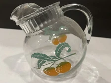 Anchor Hocking Tilt Ball Pitcher w/Ice Lip Ribbed Neck Handle Orange Motif