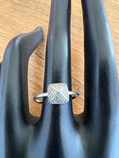 Beautiful pyramid-shaped ring with inlaid stones, made of sterling silver